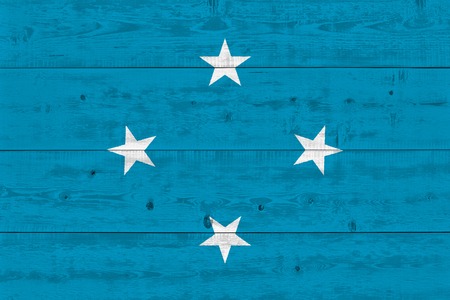 Micronesia flag painted on old wood plank. Patriotic background. National flag of Micronesiaの写真素材
