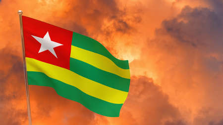 Togo flag on pole. Dramatic background. National flag of Togoの写真素材