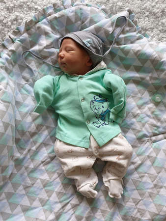 Newborn baby boy sleeping in bed