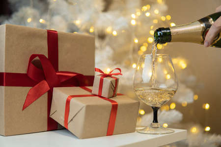 champagne poured into a glass next to gifts. high qualityの写真素材