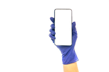 hand in medical glove holds phone. isolated on white. high qualityの写真素材