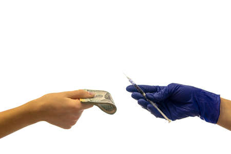 hand in medical glove holds a syringe the other hand gives money. coronavirus vaccine cost concept....