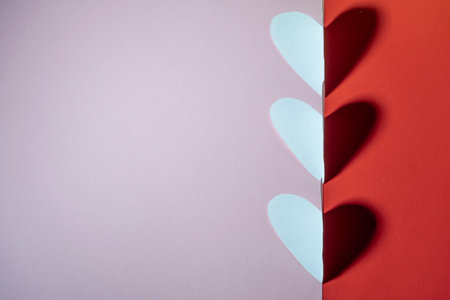 three-hearted hearts with a shadow on a red-pink background. valentine's day concept. high qualityの写真素材