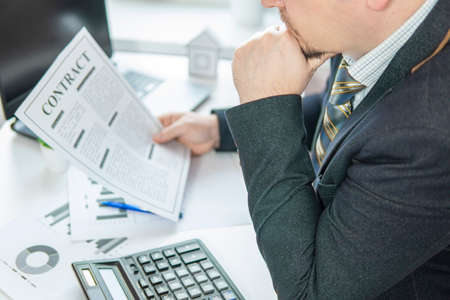 businessman at the table to sign a contract. close-upの写真素材