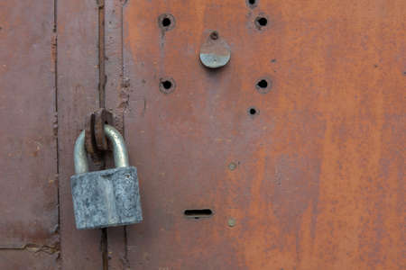 Old lock on the door. lock on the door of an old farmhouse. true village style. close-up. focus on...