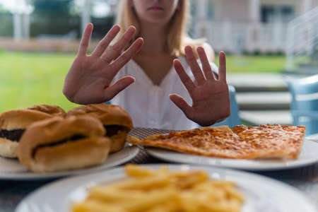 teenage girl does not want to eat fast food.の写真素材