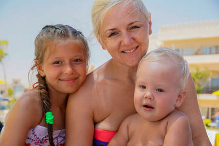 portrait mother, son and daughter on the shore of the sea.