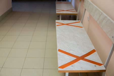 chair with X stiker for don't sit here as social distancing, Corona virus preventif with X seal tape on chair, Don't sit here.の写真素材