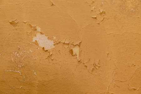 Background of old yellow painted wall with crack paint.の写真素材