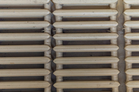 Old painted heating radiator. Pink dirty color. View from the front.の写真素材