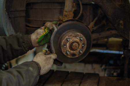 men's hands repair old brakes in the car.の写真素材