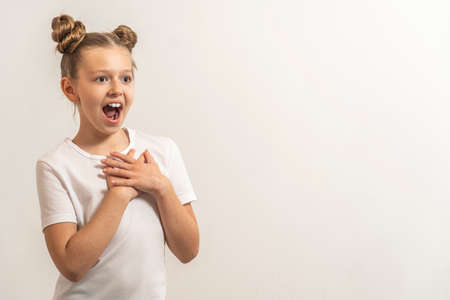 a girl with dark hair to be surprised by the light backgroundの写真素材