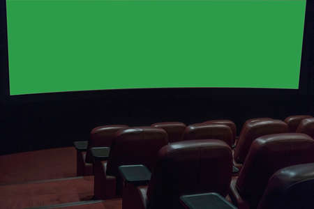 part of a movie screen and rows of brown leather chairs in an empty cinema hall in a movie theater during quarantine coronavirus.の写真素材
