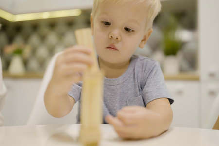 little boy have fun playing wooden block game together - board game to remove wooden blocks and kids leisure concept.の写真素材