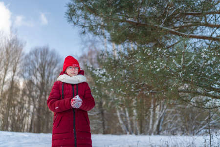 Portrait girl teenager blonde winter on the background of snow-covered trees.の写真素材