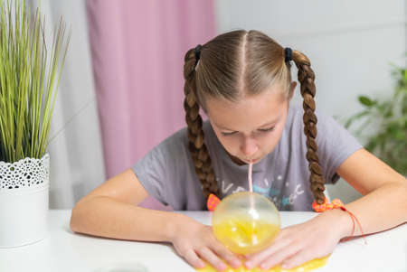 girl play with yellow slime inflates bubble fun at homeの写真素材