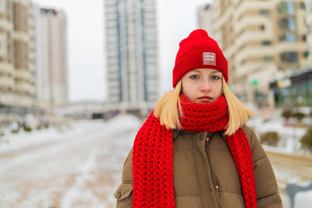 portrait girl teenager red hat winter city.の写真素材