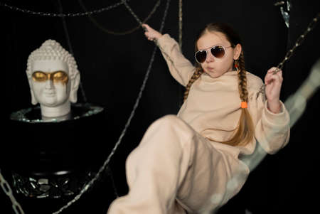 Portrait of a stylish girl on a black background.の写真素材