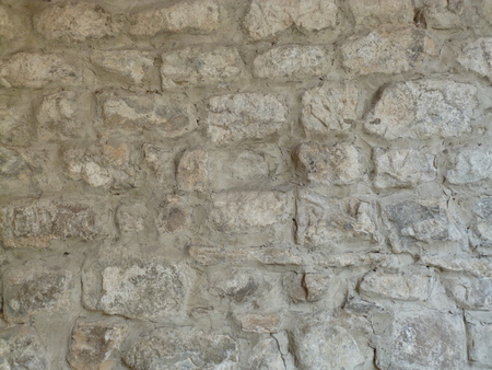 Stone Wall Photo. Old Stones Background. Stone medieval wall. real medieval masonryの写真素材