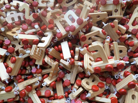 funny toy wooden letters with wheels. Background.