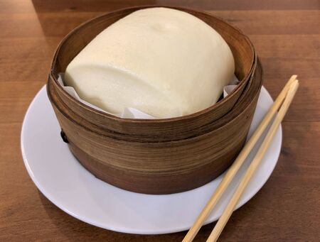 White chinese bread steamed on wood container. Chinese cuisine.