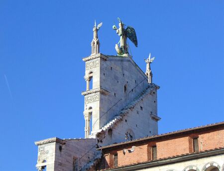 Lucca, Tuscany, Italy, January 12, 2020. The church of San Michele in Foro, architecture details. Statue of the Archangel Michael from the back side of the building.のeditorial素材