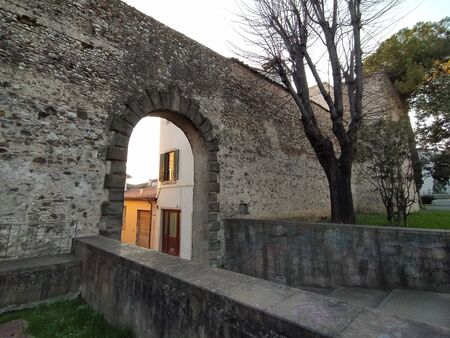 Campi Bisenzio, Tuscany, Italy, February 22, 2020. Medieval door of St. Stephen (italiano-Porta Santo Stefano) to the north, arched entrance. The north section of the old town walls.のeditorial素材