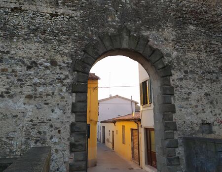 Campi Bisenzio, Tuscany, Italy, February 22, 2020. Medieval door of St. Stephen (italiano-Porta Santo Stefano) to the north, arched entrance. The north section of the old town walls.のeditorial素材