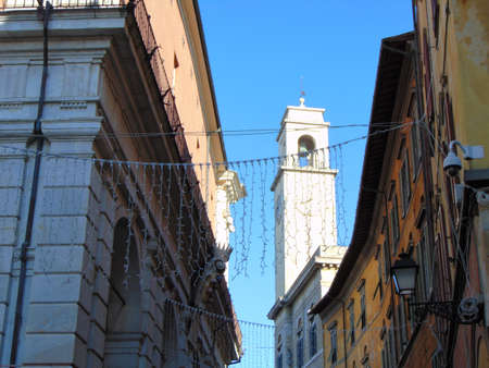Pisa Tuscany Italy. January 7th, 2019. View of the clocktower of the Palazzo Pretorio from Banchi street, adjacent to the Ponte di Mezzo bridge.のeditorial素材