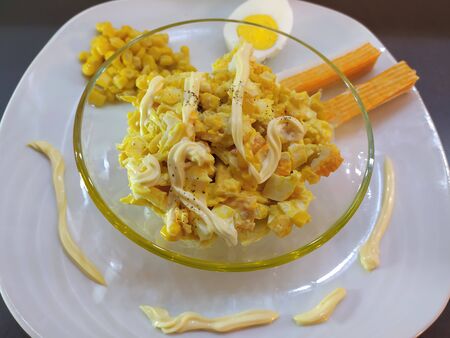 Crab sticks salad with sweet corn, eggs and mayonnaise with ingredients. Close-up.の写真素材