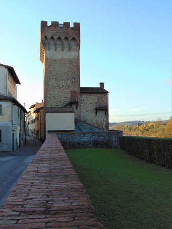 Montelupo Fiorentino, Tuscany, Italy. Town street with old houses and view of the Frescobaldi Tower, La Torre dei Frescobaldi, antique name-Torre di San Quirico at sunset, outdoor.のeditorial素材