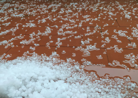 Hail, ice, close-up on the balcony tiles. Snow pellets, storm with hail. Hail after hailstorm in italyの写真素材