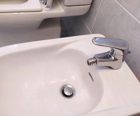 Bidets with faucet in the apartment, close-up. Bathroom faucet and sink decoration in modern bathroom interior.の写真素材