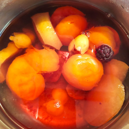Fruit compote in a pot, stewed fruit of apricots, blueberries, grapes and apples, close-up, top...