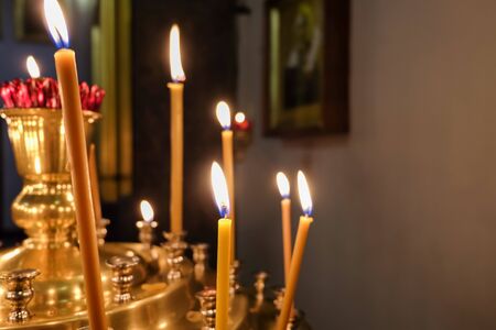 Candles in the Orthodox church, placed by believers during prayer. Selective focus. Close-up....