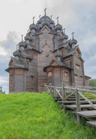Manor Bogoslovka, Leningrad region, Russia - August 15, 2020 Wooden Church of the Intercession of village estate. Architecture of north of old Russia. Historical reconstruction. Selective focus.のeditorial素材