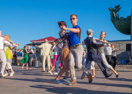 Saint-Petersburg, Russia. - August 16, 2020. Happy adults are dancing tango or waltz on the city...