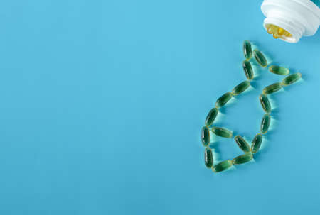 The fish oil capsules are poured out of the phlocon and form the silhouette of a fish. Super food,...