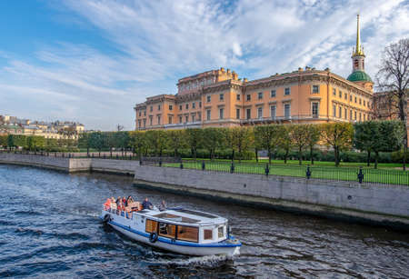 Saint-Petersburg, Russia. October 03, 2020. View of the Mikhailovsky Castle and the Moika River with a passing excursion pleasure boat. Horizontal orientation, selective focus.のeditorial素材