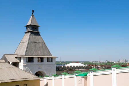 Kazan, Russia - May 19, 2021. View of the ancient historical Spasskaya tower and the wall of the...
