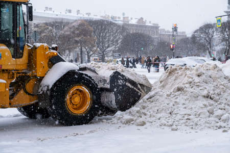 Saint-Petersburg, Russia. - December 04, 2021. Close-up of large-scale snow-plowing equipment taking part in snow removal in historical part of city during heavy snowfall. Selective focus.のeditorial素材