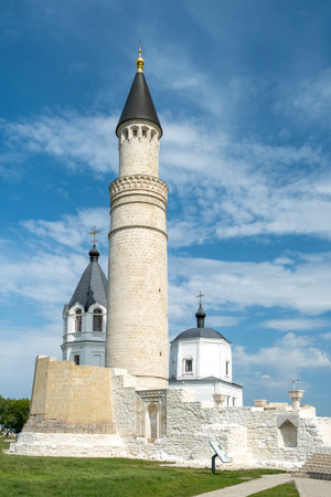 Bolgar, Tatarstan, Russia - May 24, 2023. Ancient buildings - a Muslim minor of the 14th century and a later Orthodox church. Selective focus. Vertical orientation.のeditorial素材