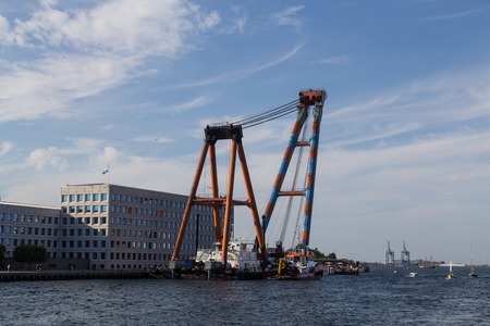 Copenhagen, Denmark - August 7, 2015: Photograph of a gigantic swimming construction crane anchored in the harbour.のeditorial素材