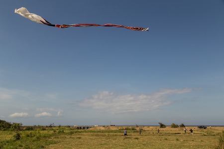 Sanur, Bali, Indonesia - July 19, 2015: A group of people is starting a gigantic kite at Sanur Beach.のeditorial素材