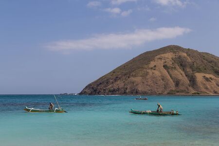Kuta, Lombok, Indonesia - July 16, 2015: Two fisherman fishing in a beautiful bay in the South of Lombok.のeditorial素材