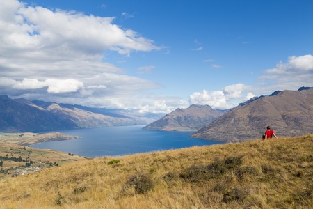 Photograph of a man enjoying the view from Queenstown Hill, New Zealand.の写真素材