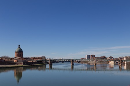 View over Garonne River in Toulouse in France towars bridge Saint-Etienne and dome of the Grave hospital.の写真素材