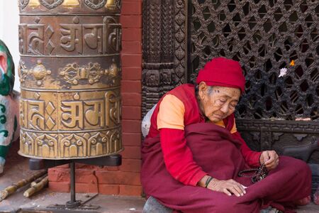 Kathmandu, Nepal - December 03, 2014: Pilgrim visiting the Buddhist Boudhanath Stupa.