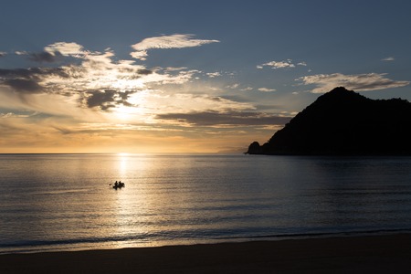 Kayaking at sunrise in Abel Tasman National Park, New Zealandの写真素材