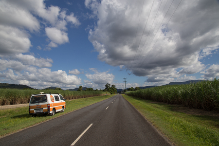 Bartle Frere, Australia - May 04, 2015: Campervan standing next to road and sugar cane fields in Queensland.のeditorial素材